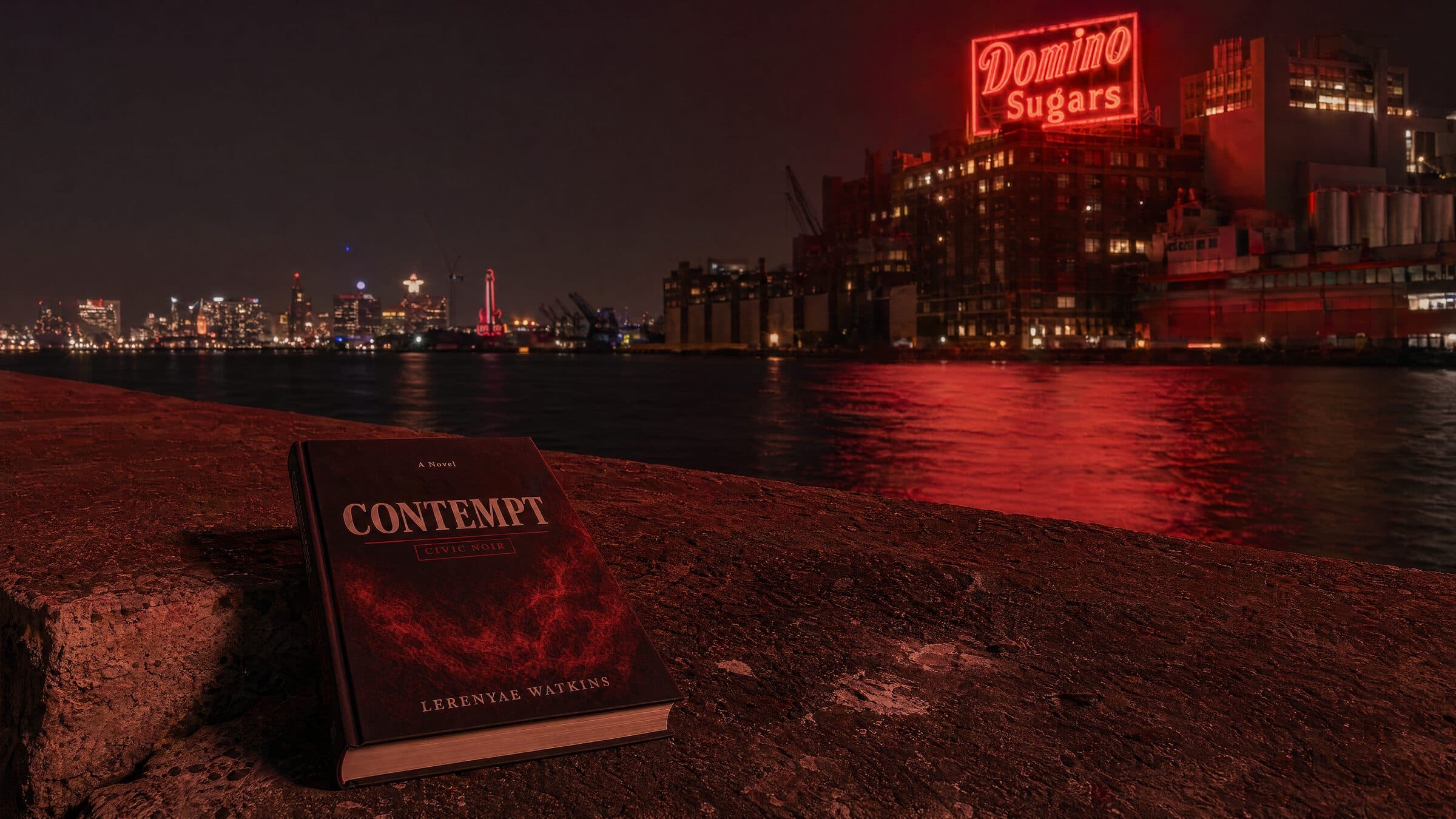 Contempt hardback under the Domino Sugars neon at the Baltimore Inner Harbor